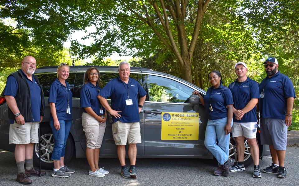 Patarja Spann (third from right) director of Rhode Island Outreach, with her team and one of the RIO response vans.