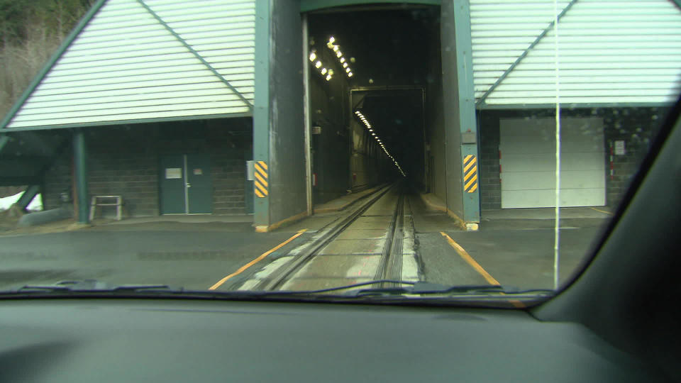 The 2.5-mile Anton Anderson Memorial Tunnel, which was converted from railroad use, alternates the flow of traffic every fifteen minutes.  / Credit: CBS News