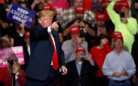 Donald Trump points at the crowd at the end of his rally on Monday - Credit: Jeff Roberson/AP