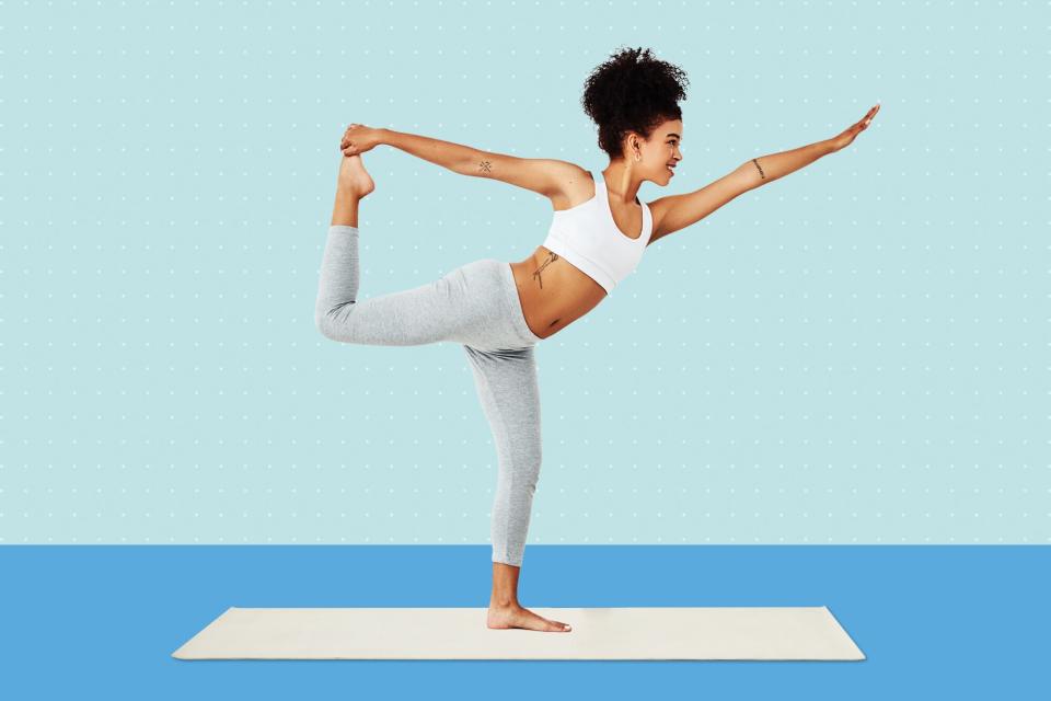 A woman balancing on one foot while doing yoga on a designed background