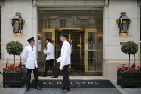 Employees wait for clients in front of the luxury hotel Le Bristol, in Paris, France, July 27, 2015. Nowhere in the world has more accommodation available on Airbnb than Paris. Now the home-sharing website that has transformed budget travel to the French capital is giving its super-deluxe hotels a fright too. Picture taken July 27, 2015. REUTERS/Stephane Mahe