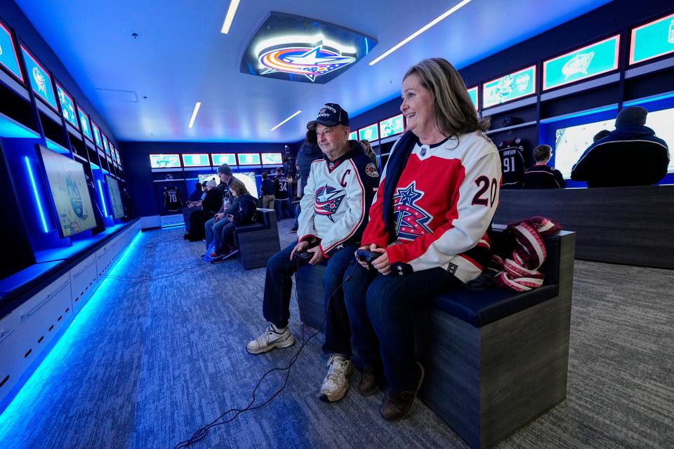 Shirley Skinn and Dave Stuthard of Powell play NHL23 on XBox in the new Fan Zone recently unveiled by the Columbus Blue Jackets.