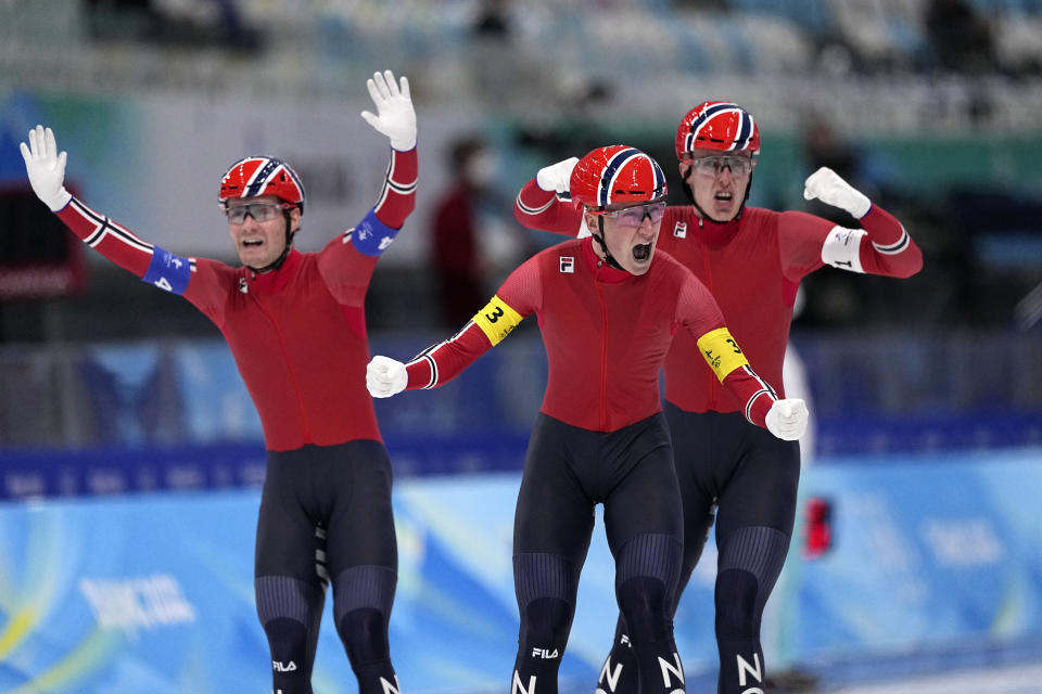 Team Norway's Peder Kongshaug, center, Sverre Lunde Pedersen, left, and Hallgeir Engebraaten react after winning the gold medal in the speedskating men's team pursuit finals at the 2022 Winter Olympics, Tuesday, Feb. 15, 2022, in Beijing. (AP Photo/Sue Ogrocki)