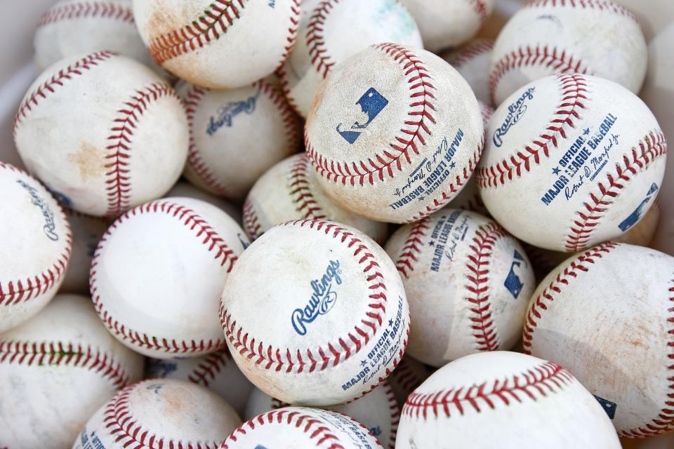 FILE - In this Feb. 14, 2017, file photo, a bucket of baseballs wait to get used for batting practice at the Cleveland Indians baseball spring training facility, in Goodyear, Ariz. The four major pro sports leagues and the NCAA think that expanding legal betting will lead to more game-fixing. The architects of New Jersey’s successful legal challenge to the sports gambling ban say those fears are overstated and that bringing sports betting out of the shadows will make it easier to detect illegal activity. (AP Photo/Ross D. Franklin, File)