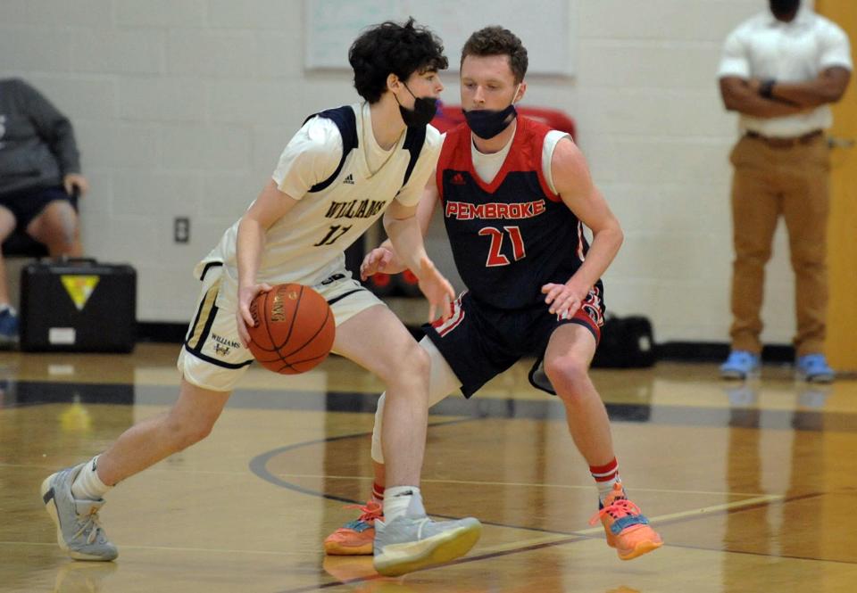 Archbishop Williams' Brendan Foster, left, drives past Pembroke defender Connor Lockhart during the Titans Holiday Classic at Pembroke High School, Thursday, Dec. 30, 2021.