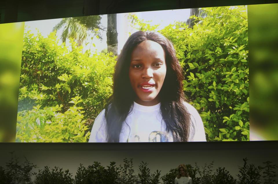 Climate activist Vanessa Nakate is seen on a giant screen as she speaks at the 'Austrian World Summit' at the Spanish Riding School in Vienna, Austria, Thursday, Sept. 17, 2020. (AP Photo/Ronald Zak)