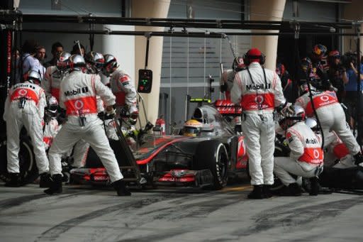 Mechanics work on the car of McLaren Mercedes' British driver Lewis Hamilton in the pits at the Bahrain international circuit in Manama during the Bahrain Formula One Grand Prix. McLaren team chief Martin Whitmarsh said that his team will be launching a full internal investigation into the pit-stop problems that threaten to derail the team's Formula One title challenge