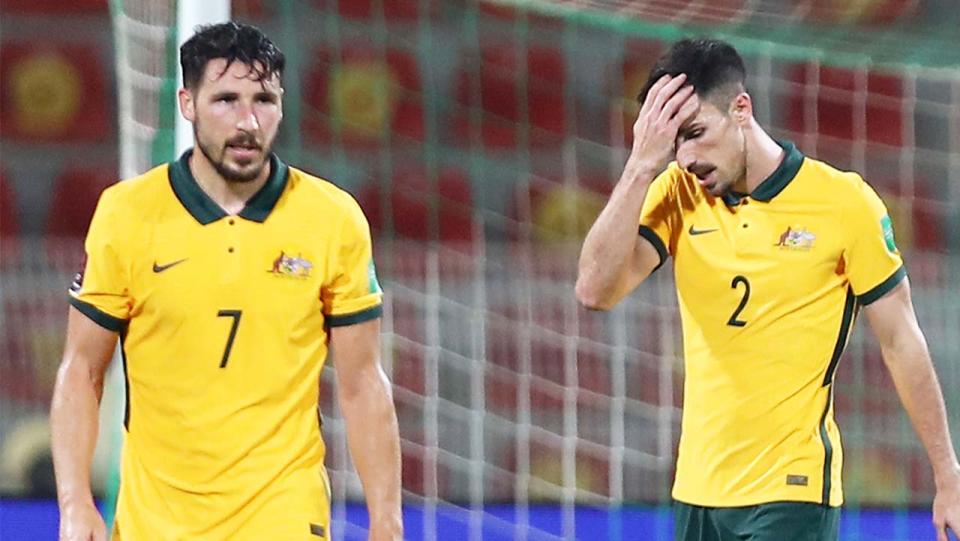 Socceroos stars Mathew Leckie and Milos Degenek look flustered after conceding a goal.