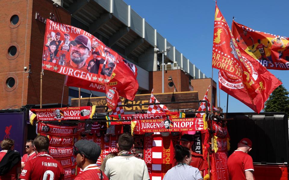 Jurgen Klopp-themed merchandise is seen for sale outside the stadium prior to the Premier League match between Liverpool FC and Wolverhampton Wanderers at Anfield on May 19, 2024 in Liverpool, England