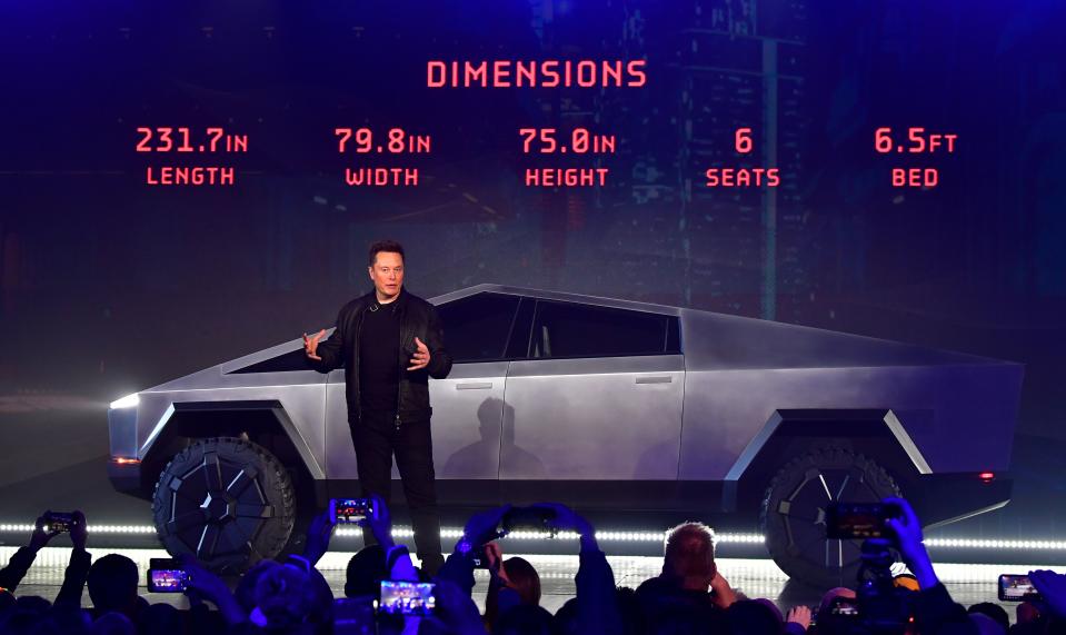 Tesla co-founder and CEO Elon Musk discusses vehicle dimensions in front of the newly unveiled all-electric battery-powered Tesla Cybertruck at Tesla Design Center in Hawthorne, California on November 21, 2019. (Photo by Frederic J. BROWN / AFP) (Photo by FREDERIC J. BROWN/AFP via Getty Images)