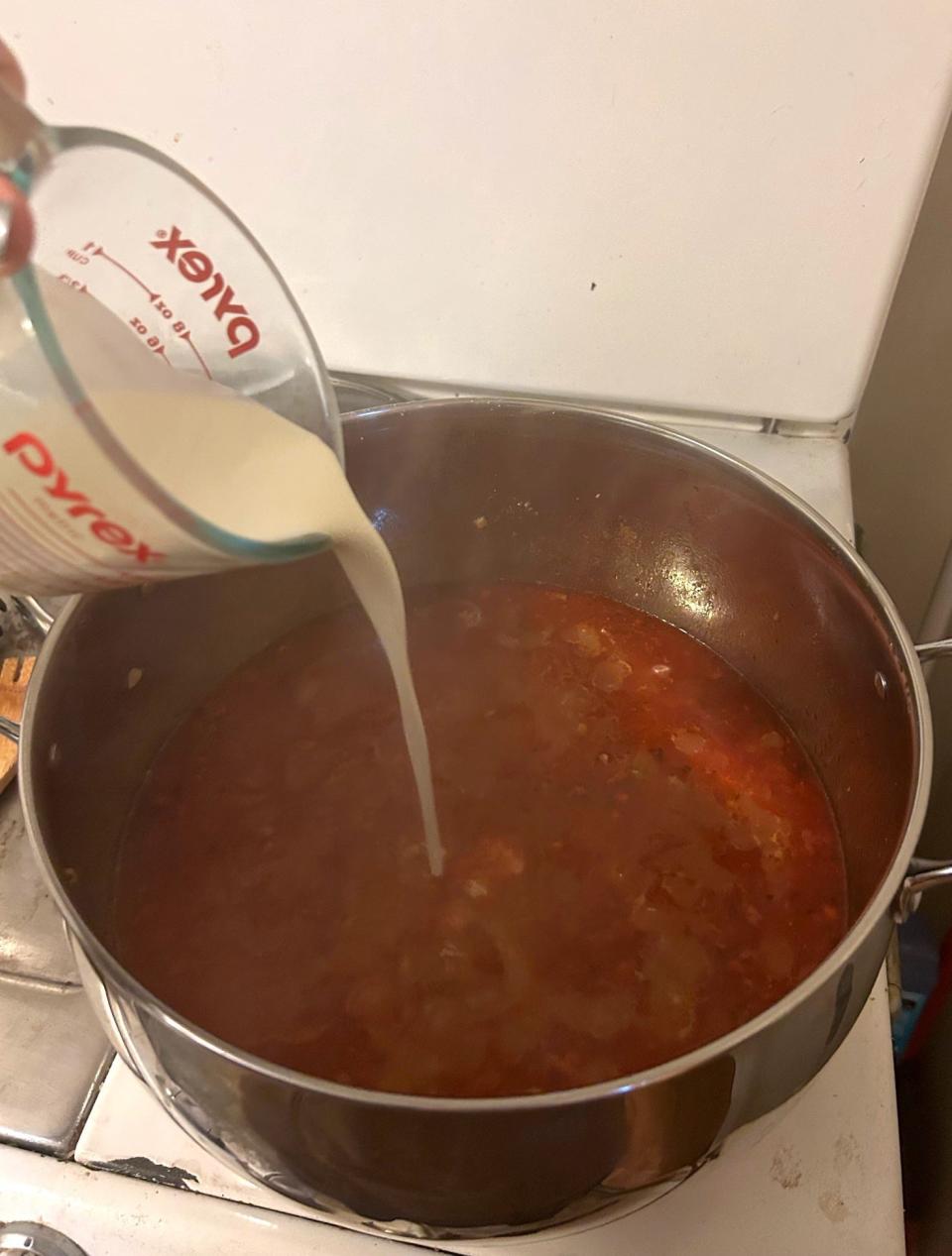 Adding cream to broth for Pioneer Woman's Lasagna Soup