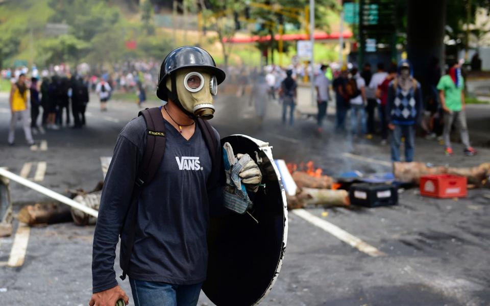 Anti-government activists set up barricades during a protest against the elections for a Constituent Assembly in Caracas - Credit: RONALDO SCHEMIDT/AFP/Getty Images