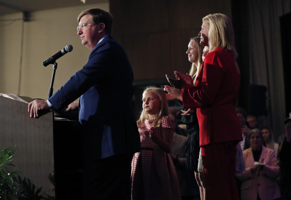 Mississippi Governor-eledt Tate Reeves addresses his supporters, as his wife, Elee Reeves, and their daughters, rear, listen, at a state GOP election night party Tuesday, Nov. 5, 2019, in Jackson, Miss. Reeves, the current lieutenant governor, defeated Democratic Attorney General Jim Hood. (AP Photo/Rogelio V. Solis)