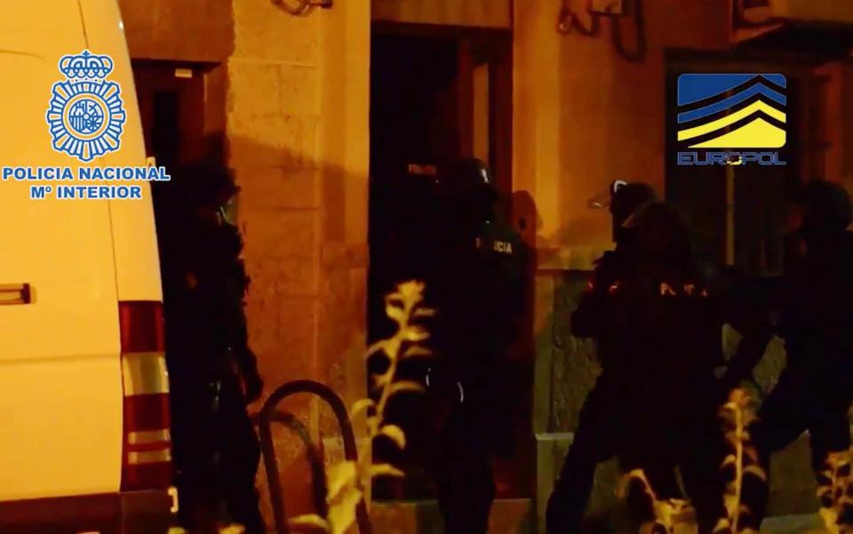 Still image from a Spanish police video showing officers raiding a building in Majorca early on Wednesday - Credit: Spain’s National Police