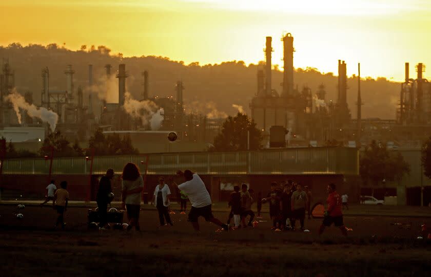 LOS ANGELES, CALIF. - OCT. 4, 2022. Youth soccer teams practice at Wilmington Waterfront Park in the shadow of the Conoco Phillips refinery. (Luis Sinco / Los Angeles Times)