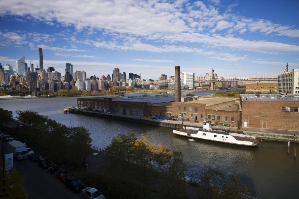 FILE- In this Nov. 7, 2018, file photo, a rusting ferryboat is docked next to an aging industrial warehouse on Long Island City's Anable Basin in the Queens borough of New York. Amazon said Thursday, Feb. 14, 2019, that it will not be building a new headquarters in New York, a stunning reversal after a yearlong search. (AP Photo/Mark Lennihan, File)