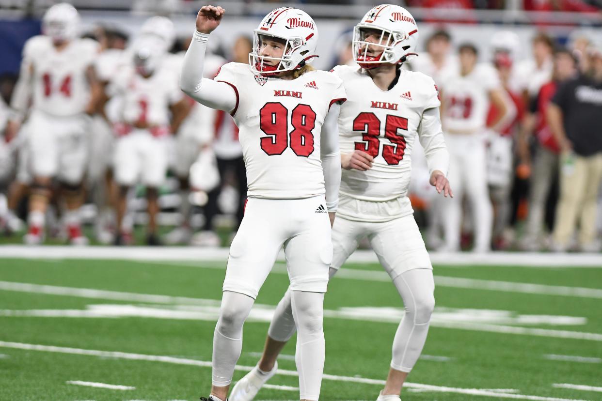 Miami University placekicker Graham Nicholson (98) and holder Alec Bevelhimer