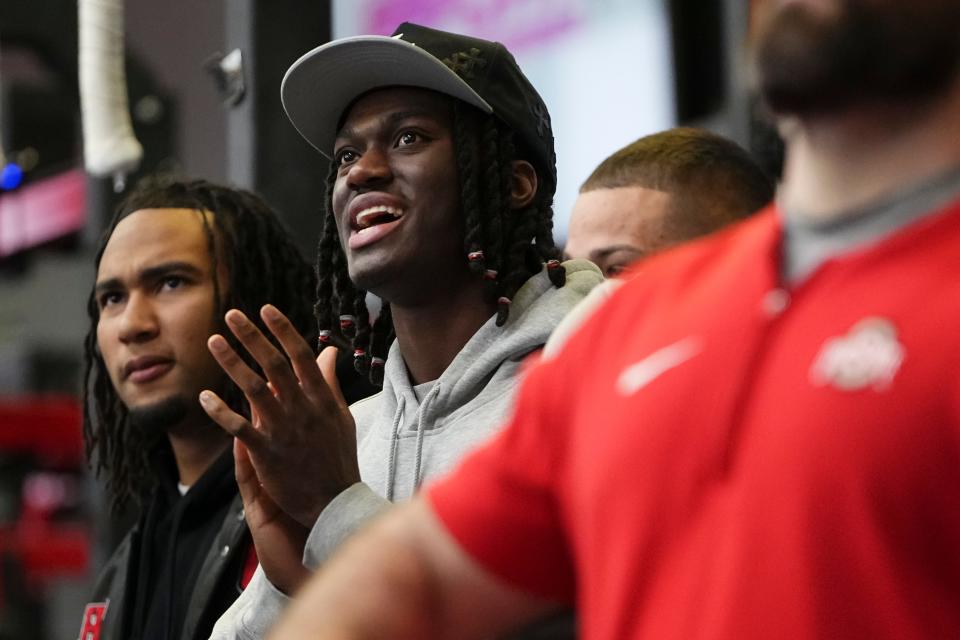 Ohio State wide receiver Marvin Harrison Jr. and Houston Texans quarterback CJ Stroud watch players bench press during pro day at the Woody Hayes Athletic Center.
