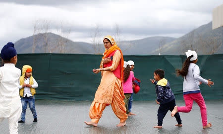 Sikh children play in the courtyard of the temple in Borgo Hermada, in the Pontine Marshes, south of Rome. Originally from India’s Punjab state, the migrant workers pick fruit and vegetables for up to 13 hours a day for between 3-5 euros ($3.30-$5.50) an hour, in Bella Farnia, Italy May 19, 2019. Picture taken May 19, 2019 REUTERS/Yara Nardi