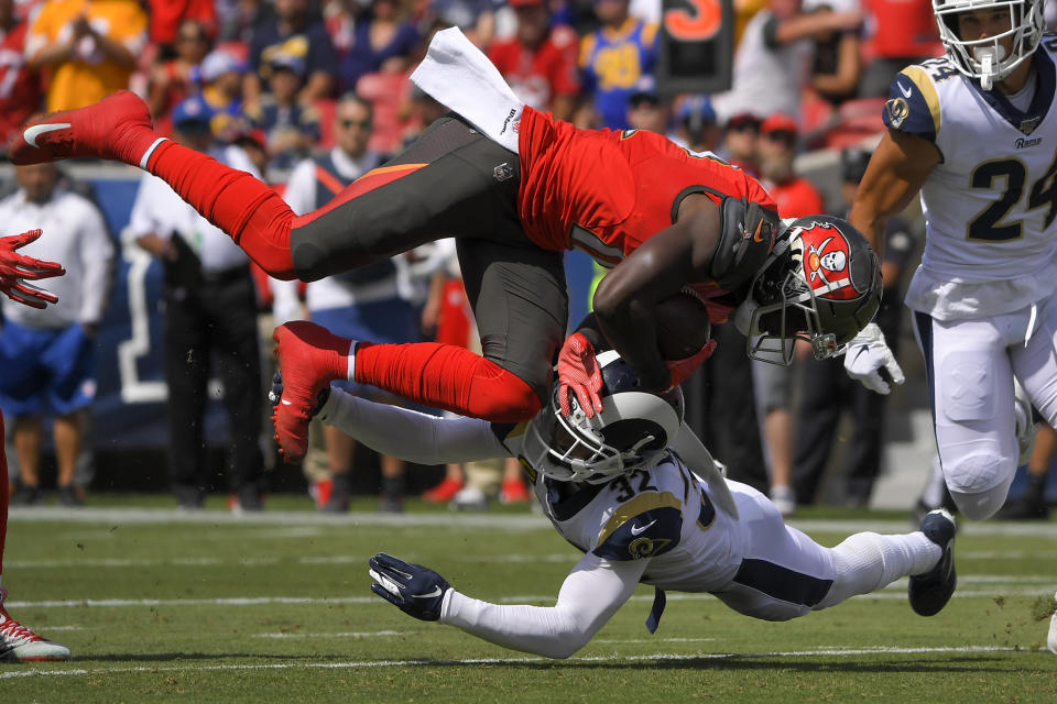 Tampa Bay Buccaneers wide receiver Chris Godwin, top, is tackled by Los Angeles Rams free safety Eric Weddle during the first of an NFL football game Sunday, Sept. 29, 2019, in Los Angeles. (AP Photo/Mark J. Terrill)