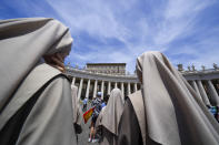 Nuns look at Pope Francis, top right, as he recites the Angelus noon prayer from the window of his studio overlooking St.Peter's Square, at the Vatican, Sunday, June 13, 2021. Francis demanded during his speech for humanitarian aid to reach residents of the war-torn Tigray region of northern Ethiopia, where Ethiopian and Eritrean soldiers are blocking food and other assistance. (AP Photo/Andrew Medichini)