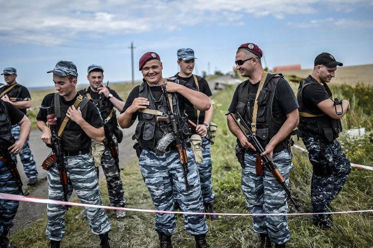 Armed pro-Russian separatists stand guard at the crash site of Malaysia Airlines Flight MH17, near the village of Grabove, east Ukraine on July 20, 2014