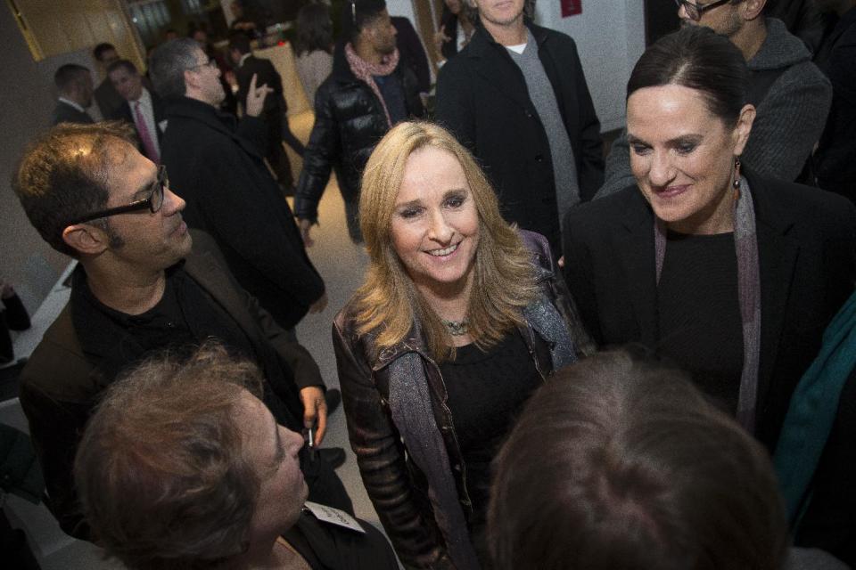 FILE - In this Dec. 9, 2013, file photo taken for the Arcus Foundation, singer-songwriter Melissa Etheridge mingles with guests at the launch of Uprising of Love, a social movement dedicated to supporting the Russia Freedom Fund, in New York. The Russia Freedom Fund, founded by Melissa Etheridge, Linda Wallem, Dustin Lance Black, Bruce Cohen and Greg Propper, works for long-term, systemic change in the status and treatment of Russia's LGBT community. (John Minchillo / AP Images for Arcus Foundation, File)