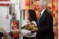 U.S. Vice President Pence and his wife help serve a Thanksgiving meal to U.S. troops in a dining facility at Camp Flores on Al Asad Air Base, Iraq