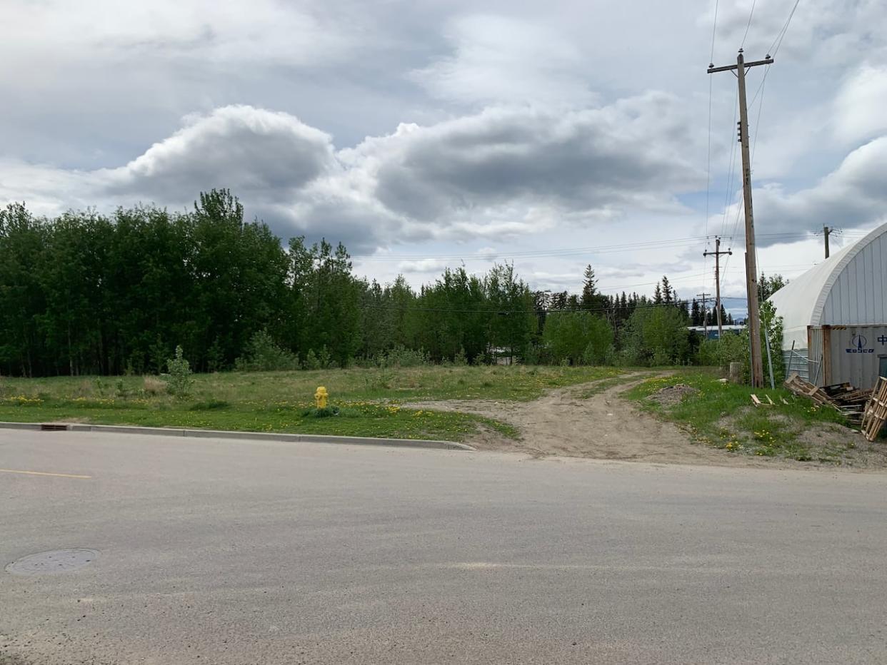 According to the Town of Hinton, the province took nearly a year to approve the closure of the undeveloped right-of-way left of the white building. The town's mayor says delays in approving road closures are hurting business and development in the community. (Submitted by Alexa Wade - image credit)