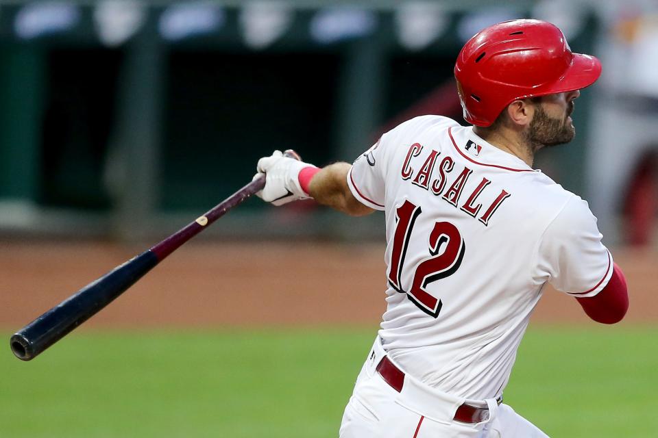 Cincinnati Reds catcher Curt Casali (12) hits a single in the third inning of a baseball game against the St. Louis Cardinals, Tuesday, Sept. 1, 2020, at Great American Ball Park in Cincinnati.