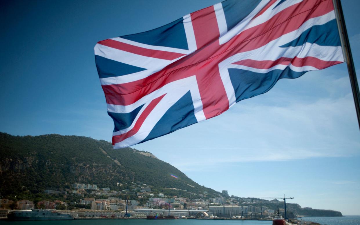 The Union Jack flies on board the Royal Navy amphibious assault ship HMS Ocean anchored at the Naval Base in Gibraltar