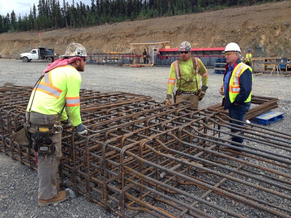 Minister Bill Bennett chats with ironworkers at Red Chris mine site during a tour of the Northwest in August 2013