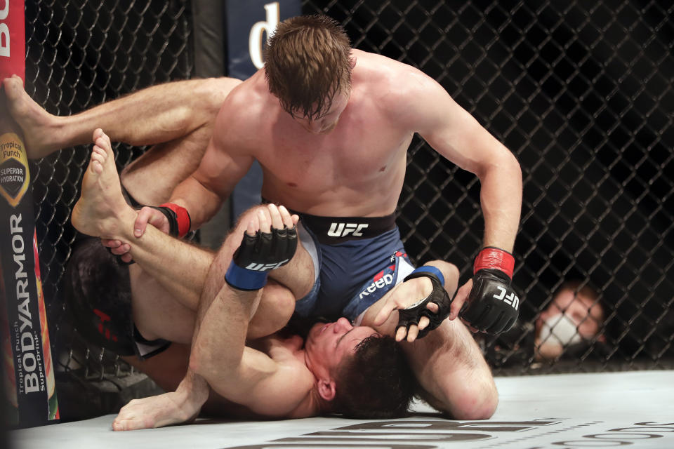 Bryce Mitchell, top, fights Charles Rosa during a UFC 249 mixed martial arts bout Saturday, May 9, 2020, in Jacksonville, Fla. (AP Photo/John Raoux)