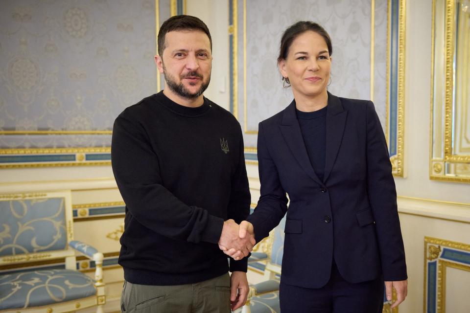 Ukraine's President Volodymyr Zelensky (L) shakes hands with Germany's Foreign Minister Annalena Baerbock (R) prior to their talks in Kyiv on Tuesday (UKRAINIAN PRESIDENTIAL PRESS SER)