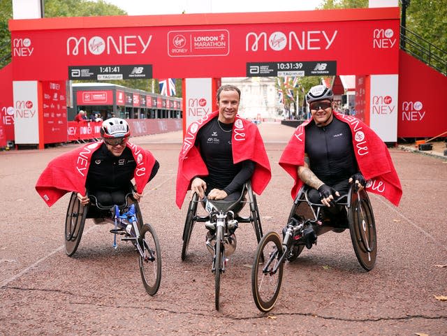 Marcel Hug (centre), David Weir (right) and Daniel Romanchuk (left) pose