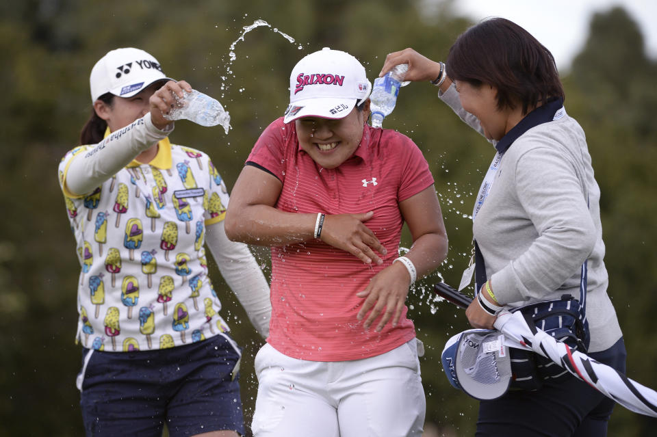 Nasa Hataoka, of Japan, is doused with water by Ayako Uehara, left and her mother, Hiromi,right, after winning the Kia Classic LPGA golf tournament, Sunday, March 31, 2019, in Carlsbad, Calif. (AP Photo/Orlando Ramirez)