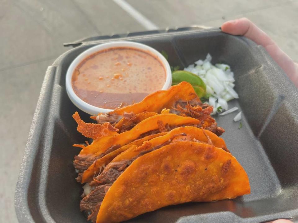 A Flores Home Cooking taco plate with corn tortillas filled with cheese and birria, and a cup of birria broth to dip, at the food truck located at 4025 Hemphill St. in Fort Worth’s Worth Heights, on April 18, 2024.