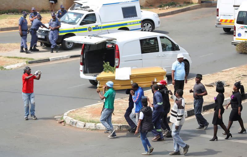 FILE PHOTO: Striking funeral workers in South Africa down tools to demand better work conditions