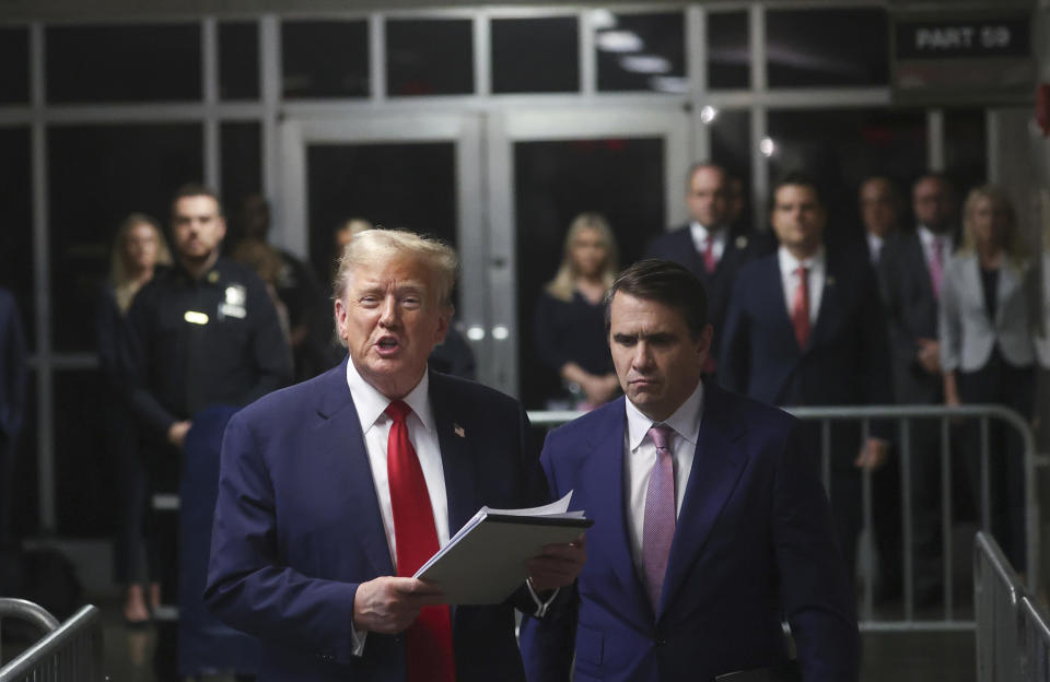 Former President Donald Trump speaks to the media, while his lawyer Todd Blanche listens, after the day's court session for his trial at Manhattan criminal court, Thursday, May 16, 2024, in New York. (Mike Segar/Pool Photo via AP)