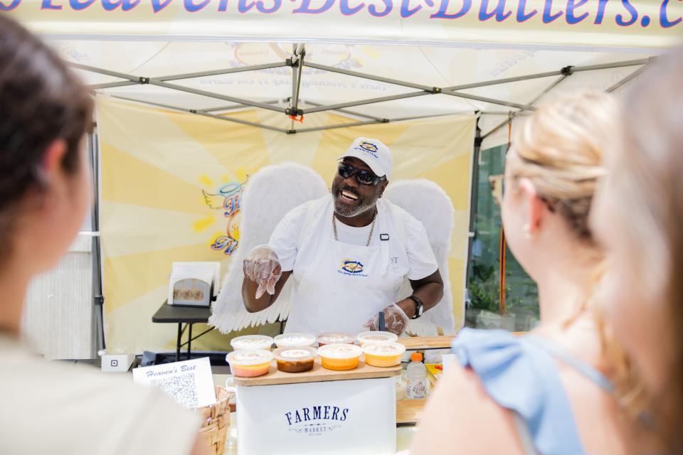 Lavarro Greer, owner of Heaven’s Best Butters, speaks to customers during the Juneteenth celebration at The Gateway in Salt Lake City on June 19, 2023. | Ryan Sun, Deseret News