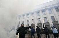 <p>Activists of nationalist groups and their supporters burn flares outside the building of the Ukrainian Parliament (Verkhovna Rada) during the so-called March of Dignity, marking the third anniversary of the 2014 Ukrainian pro-European Union (EU) mass protests, in Kiev, Ukraine, Feb. 22, 2017. (Valentyn Ogirenko/Reuters) </p>