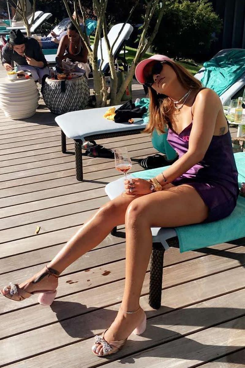 <p>Rihanna lounges poolside in Switzerland wearing a slinky purple slipdress and pink Miu Miu slides, accessorized with a glass of wine, <a href="https://www.harpersbazaar.com/celebrity/latest/news/g7612/rihanna-wine-to-go/" rel="nofollow noopener" target="_blank" data-ylk="slk:per usual;elm:context_link;itc:0;sec:content-canvas" class="link ">per usual</a>. </p>