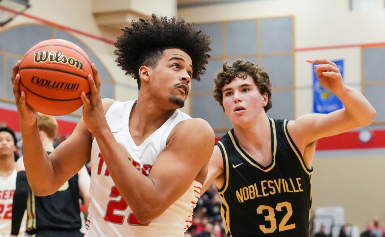 Fishers Tigers searches to score against Noblesville Millers forward Will Smits (32) on Friday, Dec. 1, 2023, during the game at Fishers High School in Fishers. The Fishers Tigers defeated the Noblesville Millers, 66-59.