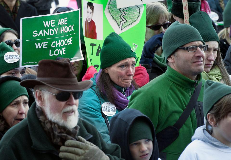 Nicole Hockley, center, mother of Sandy Hook School shooting victim Dylan Hockley, attends a rally at the Capitol in Hartford, Conn., on Feb. 14, 2013. Thousands of people  called on lawmakers to toughen gun laws after the elementary school shooting in December that left 26 students and educators dead.