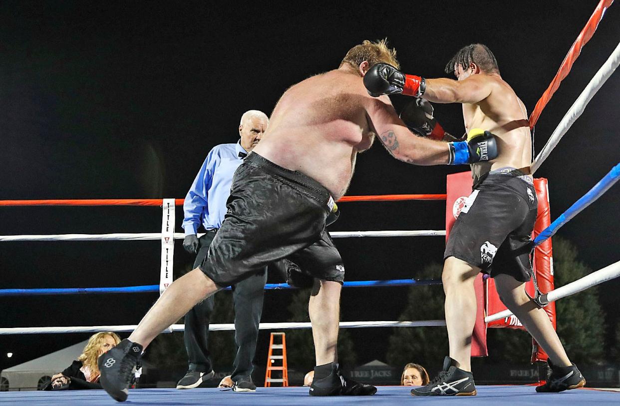 In the heavyweight division, Kevin "Big Gulp" Nagle, of Scituate, delivers a knockout body shot to end his fight against Bruno Saravia in the second round during the Granite Chin Boxing event at Quincy Veterans Stadium on Friday, Aug. 11, 2023.