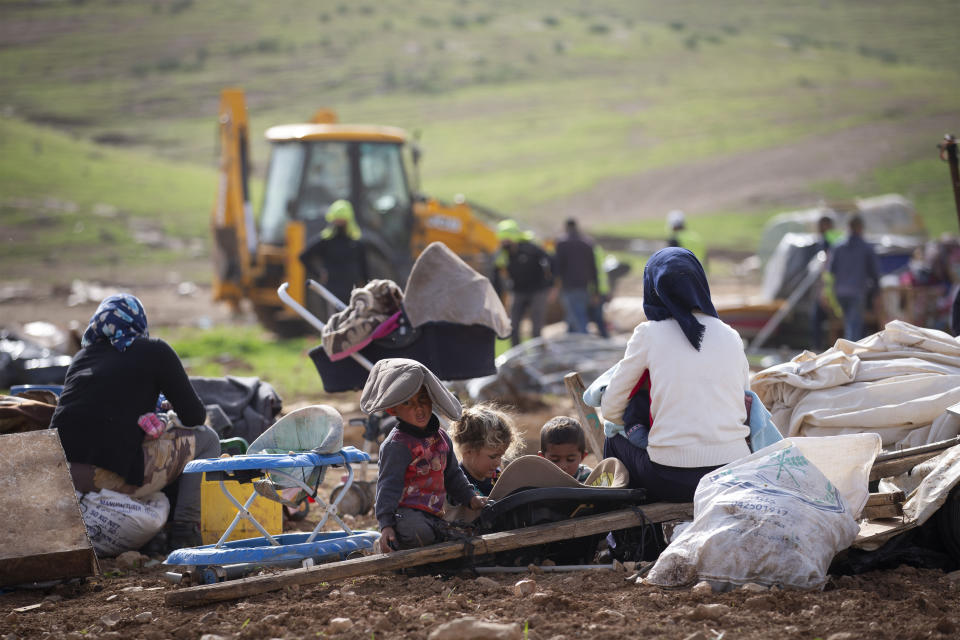 FILE - In this Feb. 3, 2021, file, photo, Palestinian Bedouin watch Israeli troops demolish tents and other structures of the Khirbet Humsu hamlet in Jordan Valley in the West Bank, Wednesday, Feb. 3, 2020. A battle of wills is underway in the occupied West Bank, where Israel has demolished the herding community of Khirbet Humsu three times in as many months, displacing dozens of Palestinians. Each time they have returned and tried to rebuild, saying they have nowhere else to go. (AP Photo/Majdi Mohammed)