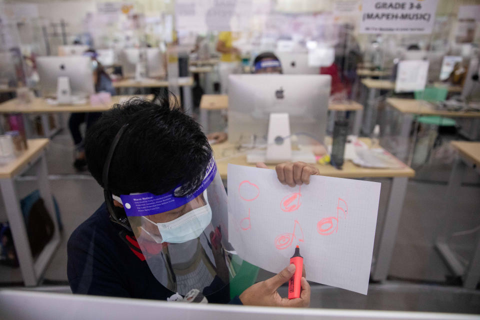 A teacher explains a lesson during a video call with a student through a hotline program, amid the coronavirus disease (COVID-19) outbreak, in Taguig City, Metro Manila, Philippines, October 7, 2020. Picture taken October 7, 2020. REUTERS/Eloisa Lopez