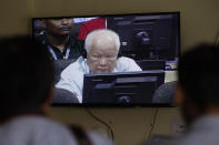 Khieu Samphan, former Khmer Rouge head of state, is seen on screen at the court's press center at the U.N.-backed war crimes tribunal on the outskirts of Phnom Penh, Cambodia, Friday, Nov. 16, 2018. The U.N.-backed tribunal judging the criminal responsibility of former Khmer Rouge leaders for the deaths of an estimated 1.7 million Cambodians will issue verdicts Friday in the latest — and perhaps last — of such trials. (AP Photo/Heng Sinith)