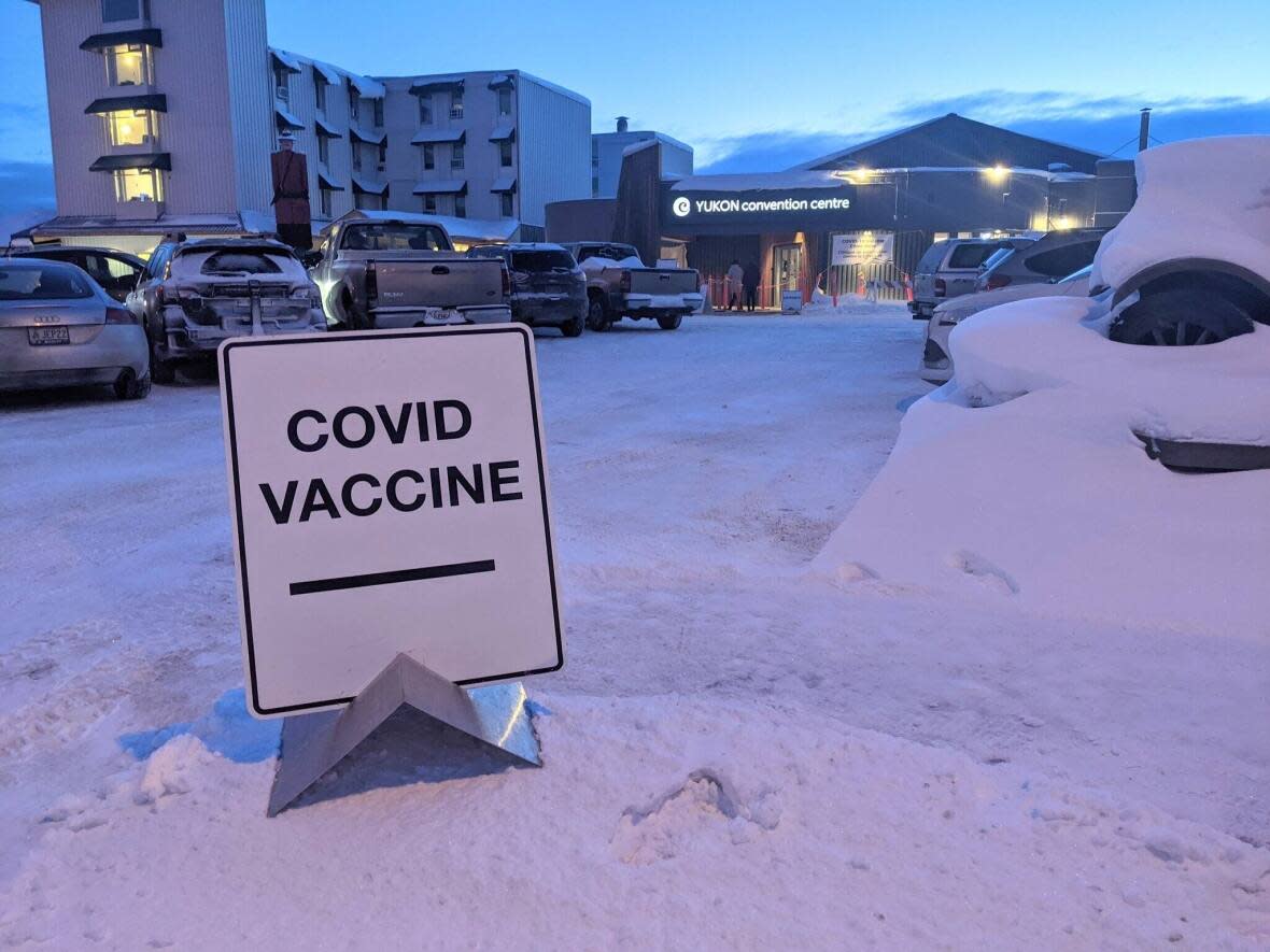 A file photo of a sign outside a Whitehorse COVID-19 vaccine clinic. The city has announced a new vaccination mandate for its employees. (Steve Silva/CBC - image credit)