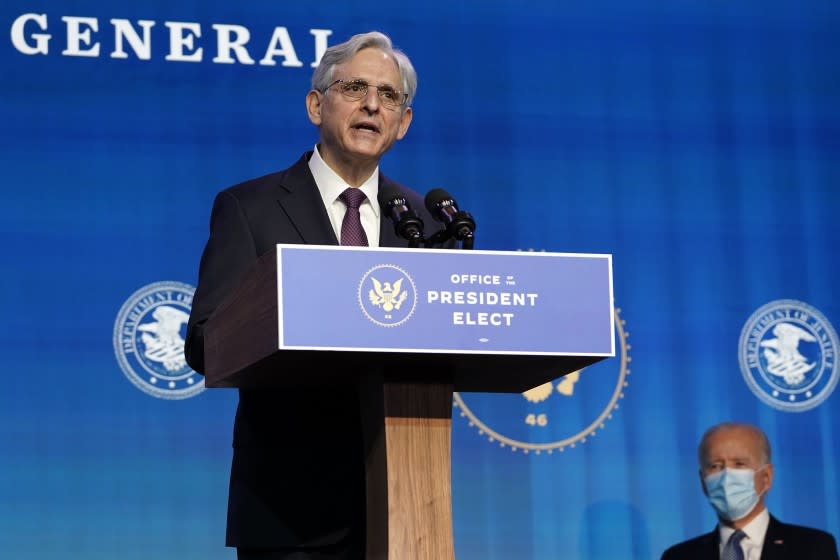 As President-elect Joe Biden listens, Attorney General nominee Merrick Garland speaks during an event at The Queen theater in Wilmington, Del., Thursday, Jan. 7, 2021. (AP Photo/Susan Walsh)